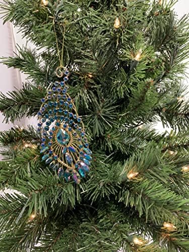 Pena de pavão de ouro com jóias azuis penduradas no Natal